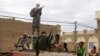  Fighters from Islamist group Ansar Dine stand guard as they prepare to publicly lash a member of the Islamic Police found guilty of adultery, in Timbuktu, Mali. (Aug 31, 2012 file photo)