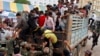 Cambodian migrant workers get off from a Thai truck upon their arrival from Thailand at a Cambodia-Thai international border gate in Poipet, Cambodia, Tuesday, June 17, 2014. 