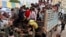 Cambodian migrant workers get off from a Thai truck upon their arrival from Thailand at a Cambodia-Thai international border gate in Poipet, Cambodia, Tuesday, June 17, 2014. 