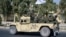 Taliban forces from the Al-Badr military corps sit on armed vehicles during a parade in Kandahar on Nov. 8, 2021.