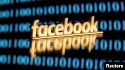 FILE PHOTO: A 3-D printed Facebook logo is seen in front of displayed binary code in this illustration picture, June 18, 2019. REUTERS/Dado Ruvic/Illustration/File Photo