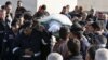 Police officers and relatives of Kamal Milkawi, one of the Jordanians killed in a shooting incident at a U.S.-funded police training facility near Amman, carry his body during his funeral in Zarqa, Jordan, Nov. 10, 2015. 