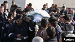 Police officers and relatives of Kamal Milkawi, one of the Jordanians killed in a shooting incident at a U.S.-funded police training facility near Amman, carry his body during his funeral in Zarqa, Jordan, Nov. 10, 2015. 
