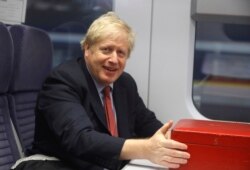 Britain's Prime Minister Boris Johnson sits on a train in London, Dec. 6, 2019, on the campaign trail ahead of the general election on Dec. 12.