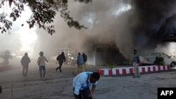 People react as a building burns after fresh protests broke out in Wamena, Indonesia's restive Papua region, Sept. 23, 2019.