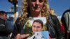 The wife of sailor Fernando Villarreal, a crew member of the missing submarine, shows his picture as she prays at the naval base in Mar de Plata, Argentina, Friday, Nov. 24, 2017.