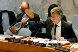 Germany's Ambassador Christoph Heusgen resets an hour glass between speakers at United Nations headquarters, April 29, 2019.