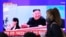 A woman passes by a TV screen showing an image of North Korean leader Kim Jong Un and his sister Kim Yo Jong during a news program at the Seoul Railway Station in Seoul, South Korea, May 2, 2020.