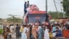 FILE - Afghan refugees board a bus from Karachi, Pakistan, to Afghanistan on Sept. 21, 2023. Afghans have poured into Pakistan by the millions during decades of wars. Pakistan on Oct. 3 ordered undocumented immigrants to leave the country by Nov. 1.