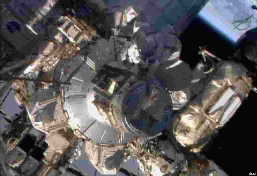 Flight engineers Michael Hopkins and Rick Mastracchio perform a series of spacewalks outside the International Space Station in this Dec. 21, 2013 still image taken from a NASA handout video.