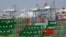 FILE - Cargo containers sit idle at the Port of Los Angeles as a back-log of over 30 container ships sit anchored outside the Port in Los Angeles, California, February 18, 2015.