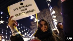 Anti-government demonstrators protest against the Georgian government's postponement of European Union accession talks until 2028, outside the parliament in central Tbilisi on Jan. 1, 2025.