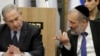 Israeli Prime Minister Benjamin Netanyahu listens to Israeli Interior Minister Aryeh Deri during a meeting with his nationalist allies and his Likud party members, at the Knesset, Israeli Parliament, in Jerusalem, March 4, 2020. 