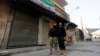 FILE - Free Syrian Army fighters look at a Syrian opposition flag in Aleppo's Bustan al-Basha district.