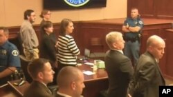 In this image made from Colorado Judicial Department video, Defendant James Holmes, top left in tan shirt, defense attorneys, top left, and prosecuting attorneys watch as the jury exits the courtroom after delivering their sentencing verdict in the Colora