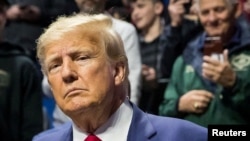 FILE PHOTO: Former President Donald Trump greets fans as he arrives at NCAA Wrestling Championships