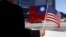 FILE - A demonstrator holds flags of Taiwan and the United States in support of Taiwanese President Tsai Ing-wen during an stopover after her visit to Latin America in Burlingame, Calif., Jan. 14, 2017.