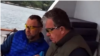 A screen grab of billionaire Oleg Deripaska (left) and Russian Deputy Prime Minister Sergei Prikhodko (R) allegedly on board the business tycoon's yacht. 