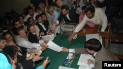Pakistan's former prime minister Nawaz Sharif (C) submits his nomination papers for the upcoming by-elections in Lahore May 13, 2008. Pakistani prime minister Yousuf Raza Gilani called for a last-ditch effort to save his government on Tuesday, after refus