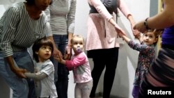 FILE - Children play in a baby-friendly cafe in Budapest, Hungary, Jan. 28, 2020. 