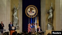 U.S. Attorney General William Barr, joined by Deputy Attorney General Jeffrey A. Rosen, delivers opening remarks at a summit on Combating Anti-Semitism at the Justice Department in Washington, July 15, 2019. 