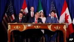 FILE - President Donald Trump, Canada's Prime Minister Justin Trudeau, right, and Mexico's then-President Enrique Pena Nieto, left, participate in the USMCA signing ceremony, Nov. 30, 2018, in Buenos Aires, Argentina.