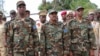 Somali President Mohamed Abdullahi Mohamed, center, Somalia Prime Minister Hassan Ali Khayre, right , and Defense Minister Abdirashid Abdulahi Mohamed watch a military unit during celebrations marking the 57th anniversary since Somali military was founded, in Mogadishu, Somalia, April 12, 2017.