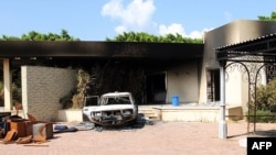 Remnants of a burned house and car inside gates the U.S. embassy compound, Benghazi, Libya, Sept. 12, 2012.