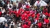 FILE - Musician turned politician Robert Kyagulanyi, center, is joined by other activists during a demonstration to protest a controversial tax on the use of social media, in Kampala, Uganda, July 11, 2018.