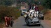 A vehicle filled with people and heavy load, precedes a convoy of over 100 trucks arriving in the Central African Republic capital Bangui from Cameroon, Monday Jan. 27, 2014. The trucks were loaded with military logistic for French forces and Humanitarian