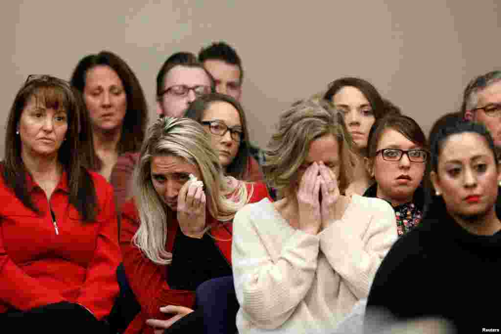 Victims and others look on as Rachael Denhollander speaks at the sentencing hearing for Larry Nassar, a former team USA Gymnastics doctor who pleaded guilty in Nov. 2017 to sexual assault charges, in Lansing, Michigan.