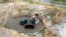 A village boy gathering water from dry sandy stream near Welaung Dam 