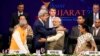 U.S. Secretary of State John Kerry (front, 2nd L) and India's Prime Minister Narendra Modi (front, 2nd R) gesture after shaking hands at the Vibrant Gujarat Summit in Gandhinagar in the western Indian state of Gujarat, Jan. 11, 2015. 