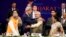 U.S. Secretary of State John Kerry (front, 2nd L) and India's Prime Minister Narendra Modi (front, 2nd R) gesture after shaking hands at the Vibrant Gujarat Summit in Gandhinagar in the western Indian state of Gujarat, Jan. 11, 2015. 