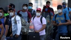 Migrants seeking a U.S. work visa are pictured after being evicted from their hotel, which local authorities said was crowded, as part of the measures to prevent the spreading of the coronavirus disease, in Monterrey, Mexico, March 24, 2020.
