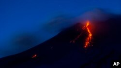 FILE - Mount Etna volcano spews lava during an eruption, Dec. 8, 2018. 
