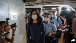 资料照：2022年7月14日，香港区域法院，警察护送曾志健走下警车。2023年10月18日星期三，在 2019 年民主抗议活动中遭警察枪击受伤的香港男子被判处47个月监禁，罪名是暴乱、袭警和妨碍司法公正。 曾志健是长达数月的抗议活动中第一位已知的警察枪击受害者。