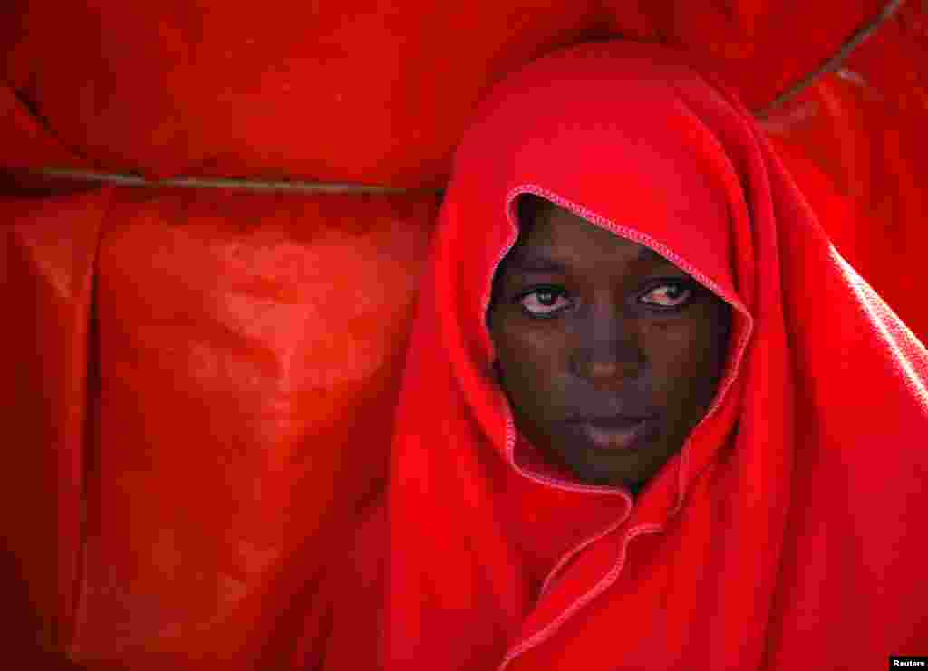 A migrant woman intercepted aboard a toy dinghy off the coast in the Strait of Gibraltar, is seen on a rescue boat after arriving at the port of Tarifa, southern Spain.