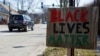 FILE - A Black Lives Matter sign is seen in Evanston, Ill., March 19, 2021. Evanston became the first U.S. city to introduce a reparations program, but some residents denounced the program as insufficient. 