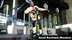 Olympic gold medalist Usain Bolt poses for a photograph as he shows off an electric scooter at a launch event in Tokyo, Japan November 15, 2019. (REUTERS/Kevin Buckland)