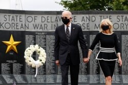 FILE - Democratic presidential candidate former Vice President Joe Biden and Jill Biden depart after placing a wreath at the Delaware Memorial Bridge Veterans Memorial Park in New Castle, Del., May 25, 2020.