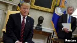 도널드 트럼프 미국 대통령이 지난 3일 백악관 집무실에서 존 볼튼 백악관 국가안보보좌관이 지켜보는 가운데 연설하고 있다. (자료사진)