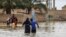 In this image shared on social media and verified by VOA Persian, a flash flood submerges buildings in western Iran’s Lorestan province, April 1, 2019. 