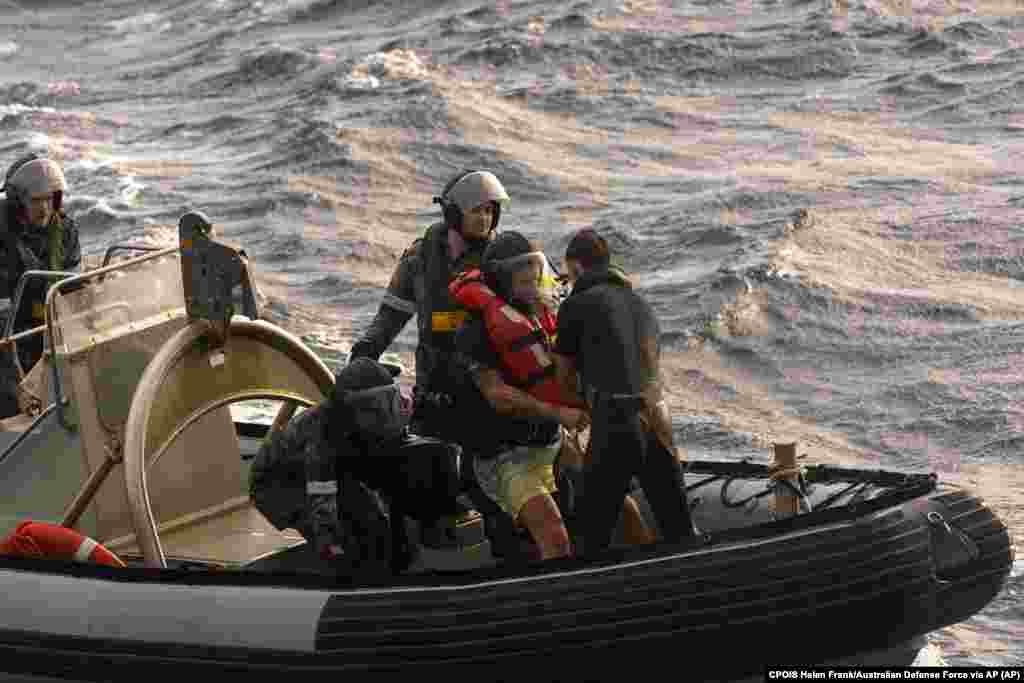 Australian Navy sailors from HMAS Choules used an inflatable boat to rescue Lithuanian rower Aurimas Mockus, second right, Monday, March 3, 2025