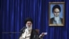 Iranian supreme leader Ayatollah Ali Khamenei delivers a speech, during a ceremony marking the 23rd death anniversary of the late revolutionary founder Ayatollah Khomeini, shown in the poster at right, at his mausoleum, just outside Tehran, Iran, June 3, 
