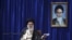 Iranian supreme leader Ayatollah Ali Khamenei delivers a speech, during a ceremony marking the 23rd death anniversary of the late revolutionary founder Ayatollah Khomeini, shown in the poster at right, at his mausoleum, just outside Tehran, Iran, June 3, 