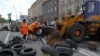 FILE - Municipal workers remove tires as they dismantle barricades set up during the protests that toppled Moscow-backed president Viktor Yanukovych in central Kyiv, July 1, 2014. 