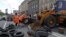 FILE - Municipal workers remove tires as they dismantle barricades set up during the protests that toppled Moscow-backed president Viktor Yanukovych in central Kyiv, July 1, 2014. 