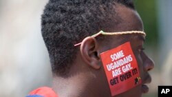 FILE - A Ugandan man is seen during LGBT Pride celebrations in Entebbe, Uganda, Aug. 9, 2014. Nineteen members of the country's LGBT community were arrested last month for gathering in public in violation of a coronavirus lockdown.