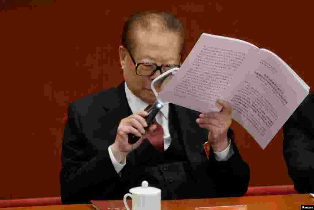 អតីត​ប្រធានាធិបតី​ចិន​លោក Jiang Zemin ប្រើ​កែវពង្រីក​នៅពេល​ដែល​លោក​អាន​របាយការណ៍​របស់​លោកប្រធានាធិបតី​ចិន​ Xi Jinping អំឡុង​ការ​បើក​ការ​ប្រជុំ​សភា​របស់​គណបក្ស​កុំម្មុយនីស្ត​ចិន​​នៅ​ក្នុង​មហាសាល​ប្រជាជន​ក្នុង​ទីក្រុង​ប៉េកាំង​។